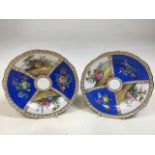 A pair of hand painted Meissen quatrefoil plates with cut marks to blue swords W:21cm