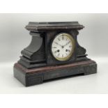 A black slate Victorian mantel clock with a 4-inch white dial, moon hands, two train French movement
