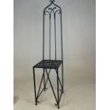 A Wrought iron high backed chair.