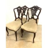A set of four 20th century upholstered dining chairs with carved backs. Seat height H:47cm