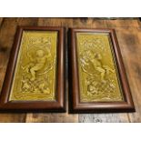 A pair of framed tiles depicting angels playing musical instruments in modern frames. W:22cm x H: