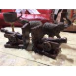 A pair of wooden bookends styled as canons, a pair of resin elephants and a green goblet