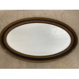 An oval bevel edge mirror with gilded surround. A/F W:78cm x H:50cm