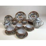 A Japanese Kutani egg shell porcelain part tea set with tea cups, saucers and plates, also with
