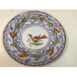 A hand painted platter possibly 19th century decorated with a naive bird W:34cm