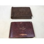 Two cigarette card albums. One featuring Players cigarette cards of film stars, dinosaurs,