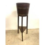 An early 20th century oak Lister style coopered jardiniere with lower shelf. H:91cm