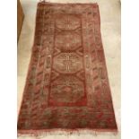 A red and cream Persian rug with four central medallions.