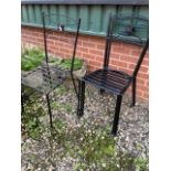 Four garden metal stacking chairs.