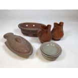 A stoneware lidded fish dish with other stoneware and pottery items