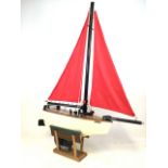 A large wooden hand painted model yacht on stand. H:138cm