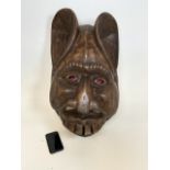 A very large wooden carved mask. W:44cm x D:28cm x H:70cm