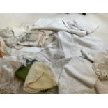 A quantity of vintage tableware including embroidered napkins, doillies, tablecloths and others