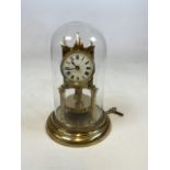 A Gustav Becker style brass anniversary clock under glass dome with key. H:28cm