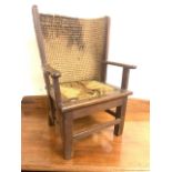 An antique arts and craft childrens Orkney chair. Oak frame with drop in seat. With curved rush