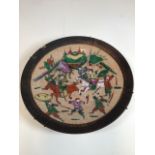 A Chinese crackle glaze charger decorated with warriors. Four character mark to underside. Chip to