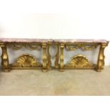 A near pair of modern gilt marble topped console tables W:133cm x D:37cm x H:78cm