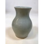An art pottery pale green glazed vase - see mark photographed W:15cm x H:20cm