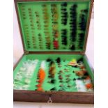 A box of fishing flies. W:40cm x D:30cm x H:8.5cm