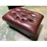 A red leather buttoned footstool on turn legs with stud work finish. Size W x 74 CM DX 53CM H X