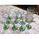 A set of green stemmed vintage hock glasses and a mid century glass jug
