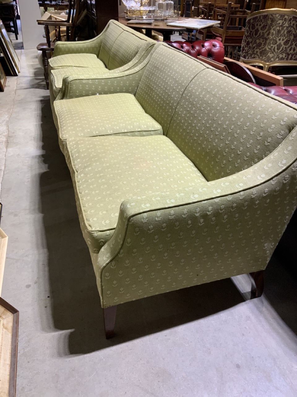A pair of early 20th century two seater sofas. On tapered oak legs. W:160cm x D:80cm x H:76cm