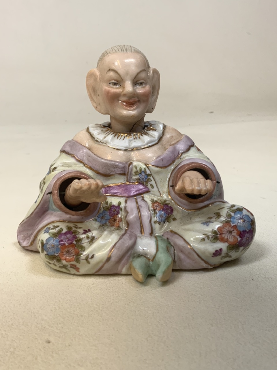 A 19th century porcelain Mandarin nodding hands and head figurine with blue factory anchor mark.