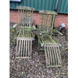 A pair of teak garden reeling steamer chairs with cushion