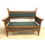 An arts and crafts style early 20th hall bench with drop in seat. With carved Mashibra style panels.