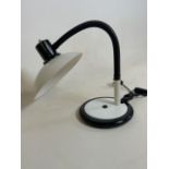 A Flexible desk lamp on weighted base.