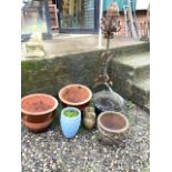 A pair of ceramic planters a metal bucket and tripod lantern.