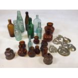 A box of vintage bottles also with some horse brasses also includes stoneware bottles