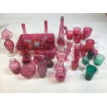 A quantity of cranberry and other glass including glasses, jugs, vases, a tray, bowls and other