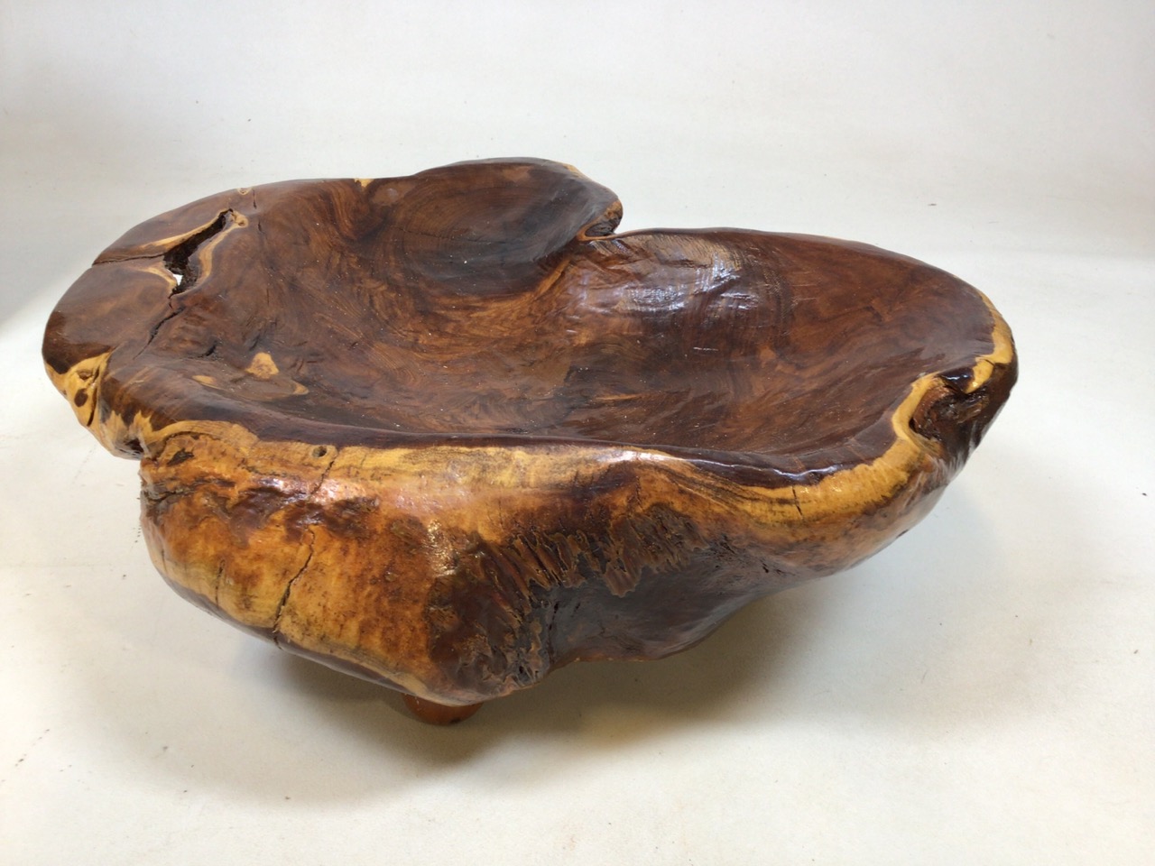 A carved wooden bowl on feet