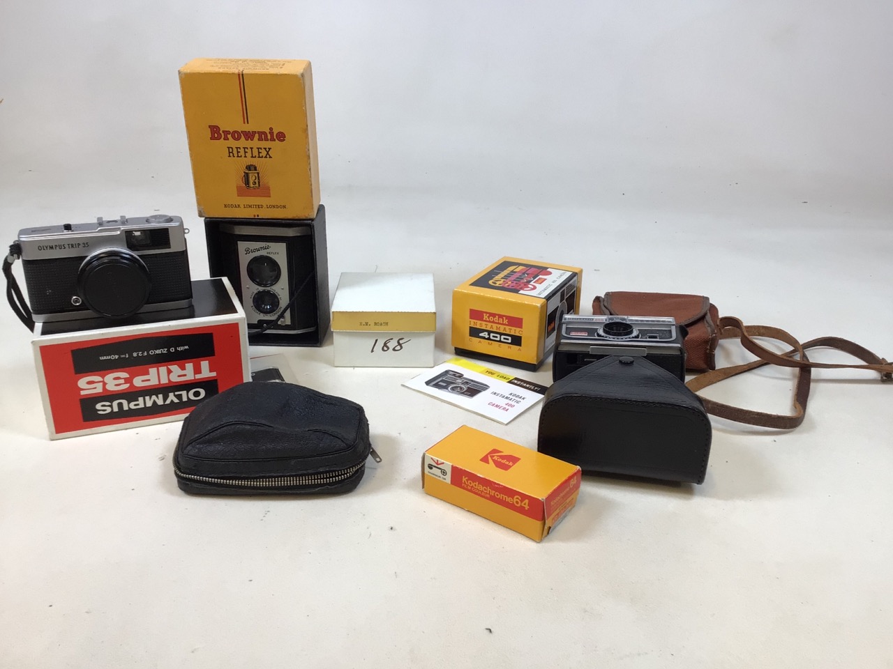 A Kodak Instamatic 400 camera in original box, a Brownie Reflex in original box and an Olympus