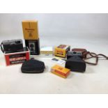 A Kodak Instamatic 400 camera in original box, a Brownie Reflex in original box and an Olympus