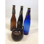 Three vintage glass bottles with white metal decorative trim on necks also with another and a