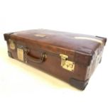 A Vintage leather suitcase with travel and other vintage labels. W:70cm x D:43cm x H:23cm