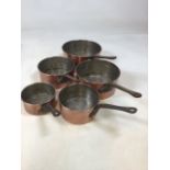 A set of 5 copper coloured saucepans. Largest pan diameter 21cm, smallest 13cm