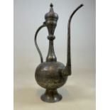 An large Persian metalwork water jug with heavily engraved detail. H:69cm