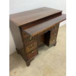 A George III mahogany kneehole desk with brushing slide width 82.5 cm.