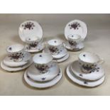 A six piece Shelley fine bone China tea set decorated with violets, interesting notches on rim of