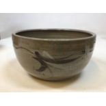 An art pottery bowl by Russell Collins glazed and decorated with abstract design
