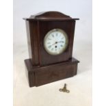 A wooden mantle clock with key W:30cm x D:15cm x H:38cm also with a round glass topped table