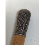 A walking stick with white metal top carved with Chinese scene and figures