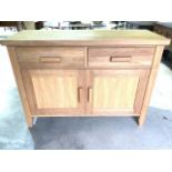 A modern oak sideboard with two drawers above cupboards. W:120cm x D:46cm x H:86cm