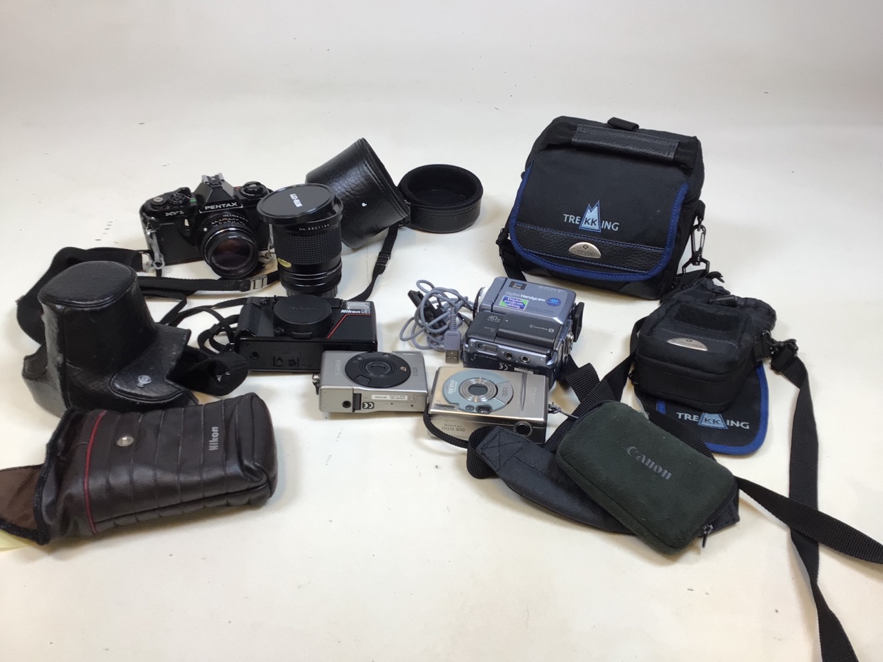 A quantity of cameras and accessories including Sony mini DV video camera, digital Canon Ixus