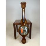 A modern inlaid barometer by Comitti Holborn also with a small tiled top G Plan style table.