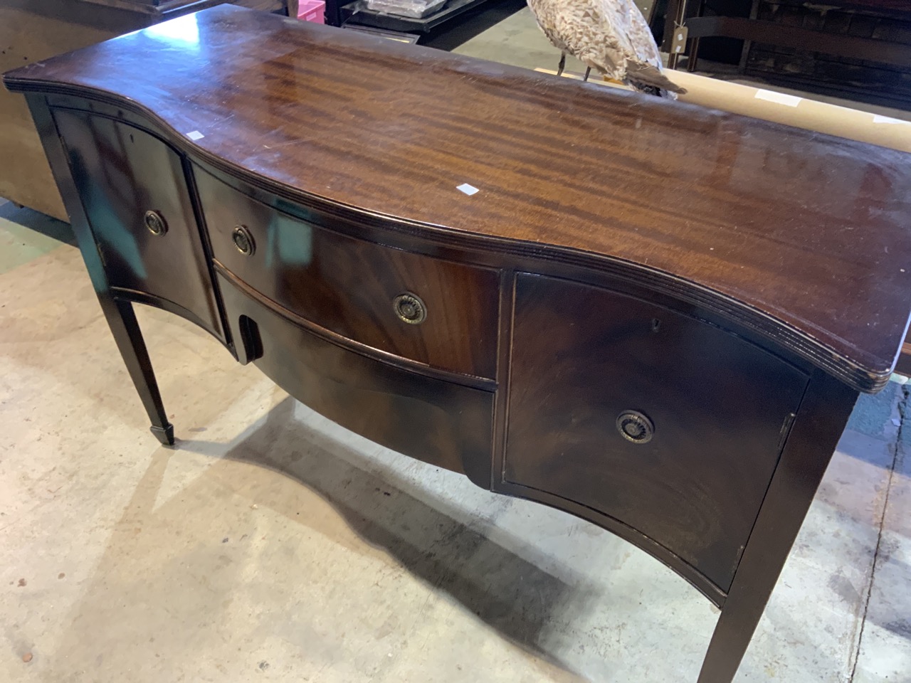 A serpentine fronted sideboard, 20th century, two middle drawers flanked by cupboards. W:141cm x D: - Image 2 of 3