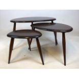 A nest of three dark wood Ercol Pebble tables. Ercol sticker to base 1979 W:85cm x H:41cm Largest